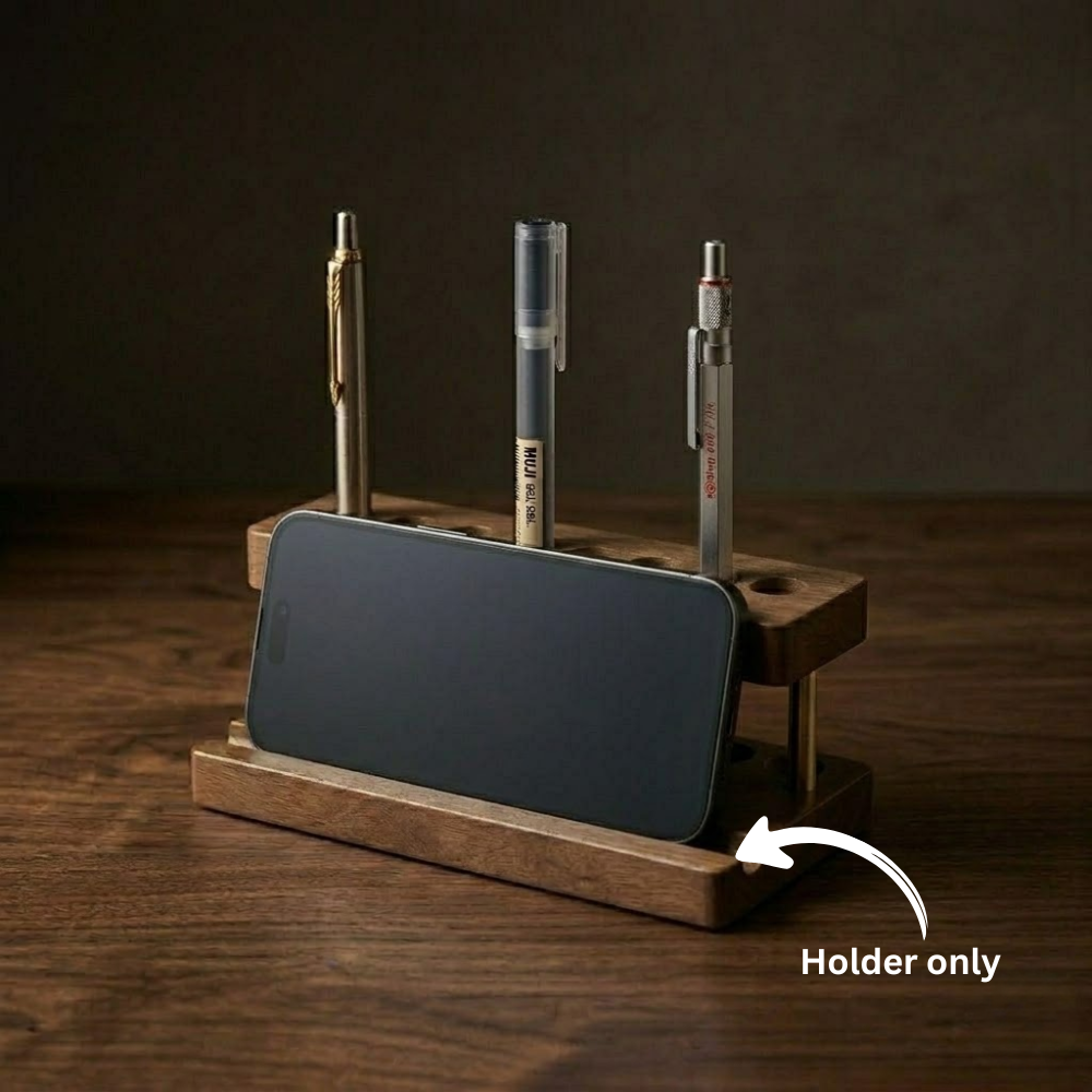 Warm evening desk setup highlighting a walnut phone stand holding a mobile device