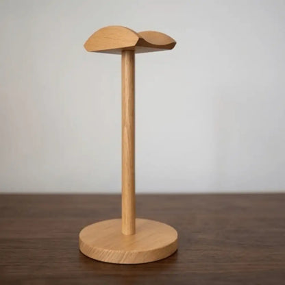 Light wood headphone stand variation placed on a clean desk