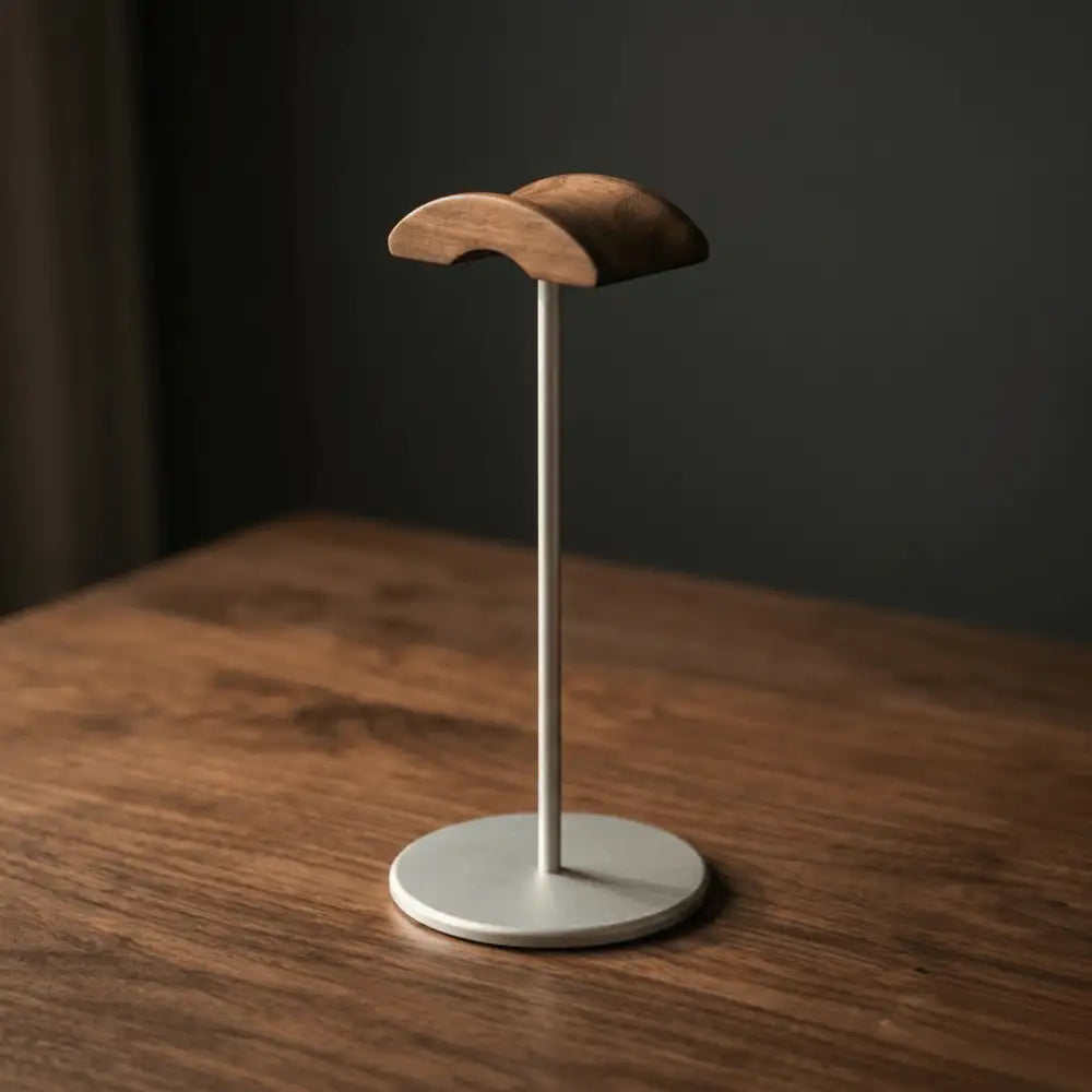 Walnut desk headphone stand on a wooden desk surface