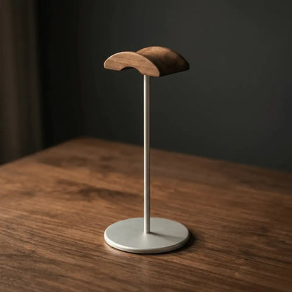 Walnut desk headphone stand on a wooden desk surface