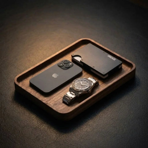 Men's valet tray holding a phone, wallet, and wristwatch on a desk