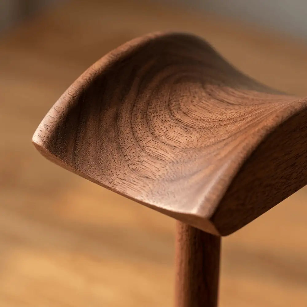 Close-up of solid walnut wood grain on a wooden headphone stand