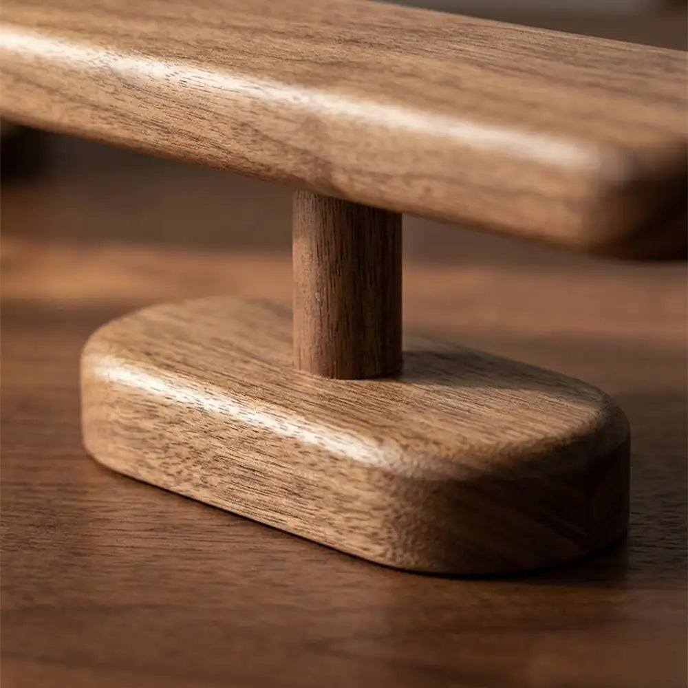 Close-up detail showing the wood grain and sturdy base of the walnut watch display stand