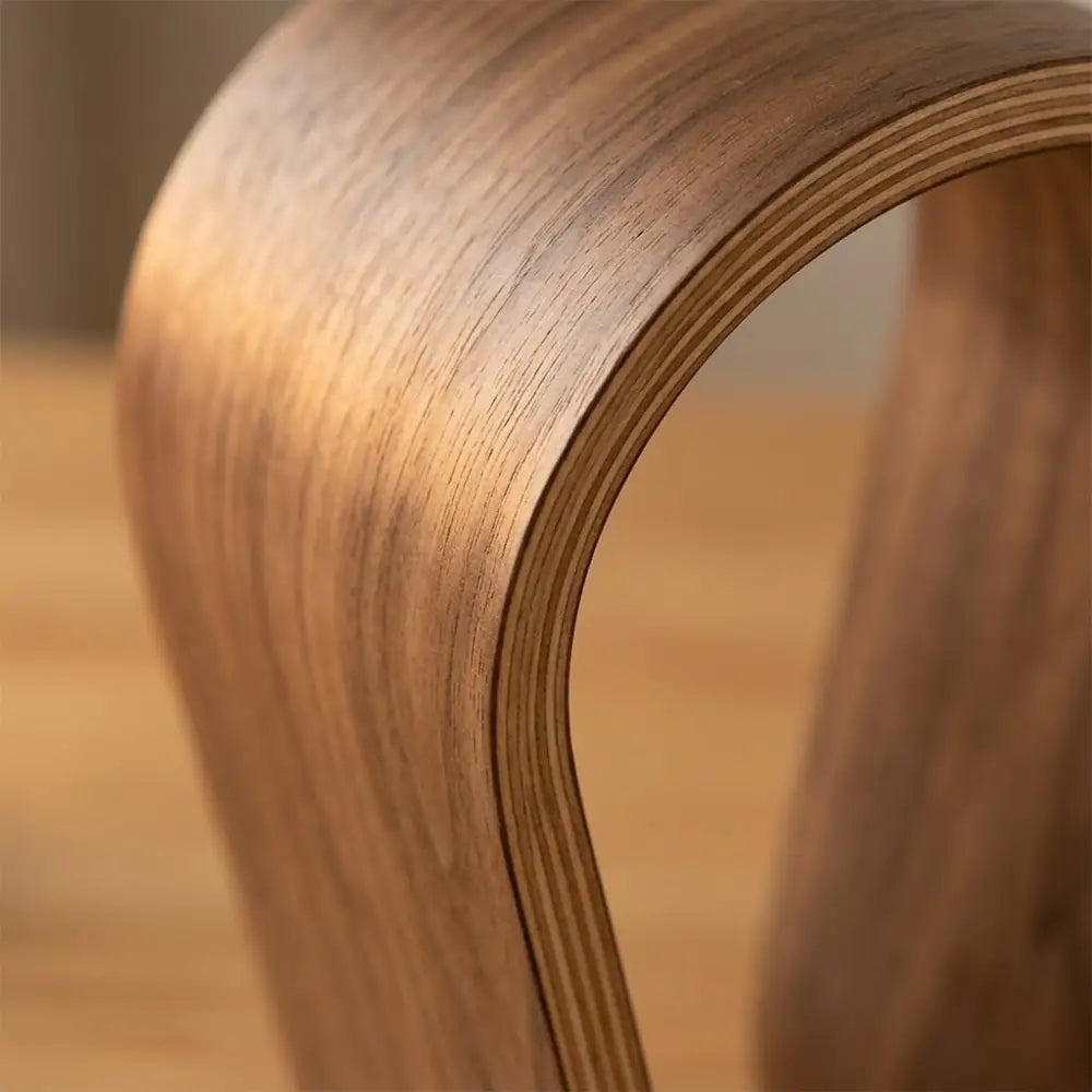 Close-up of curved walnut wood headphone stand structure
