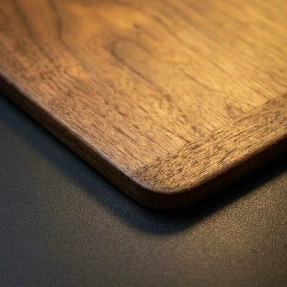 Close-up of solid walnut wood grain and finish on the mouse pad