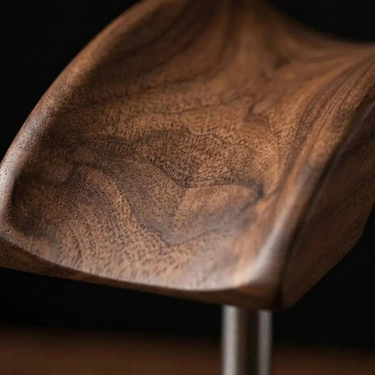 Close-up of walnut wood grain and curved headphone stand rest