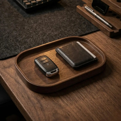 Minimalist valet tray for desk setup organizing everyday carry items on dark walnut wood desk